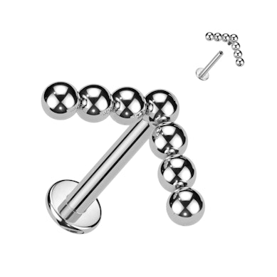 Labret de titanio con diseño de bolitas en flecha
