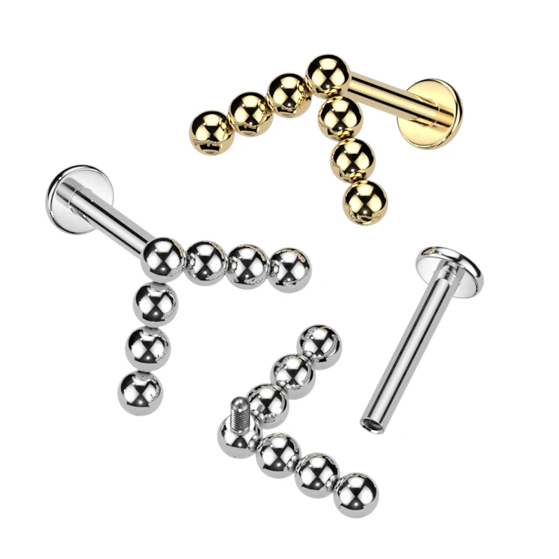 Labret de titanio con diseño de bolitas en flecha