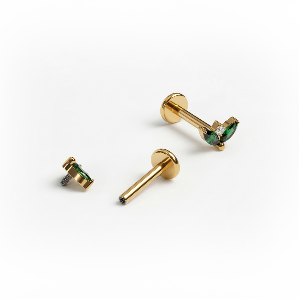 Labret de titanio con dos piedras esmeralda